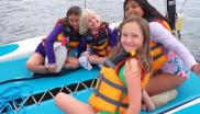 Kids on a boat with life jackets Kids on a boat with life jackets