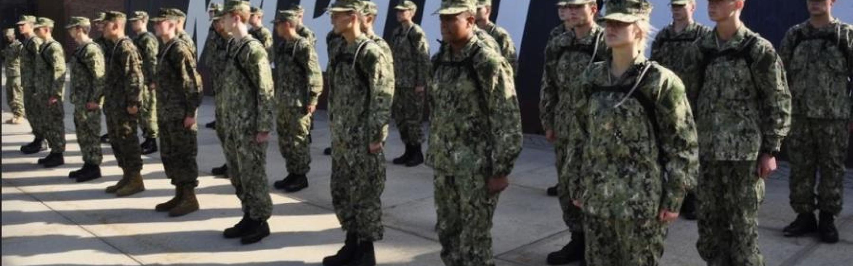 People standing in a row dressed in uniforms